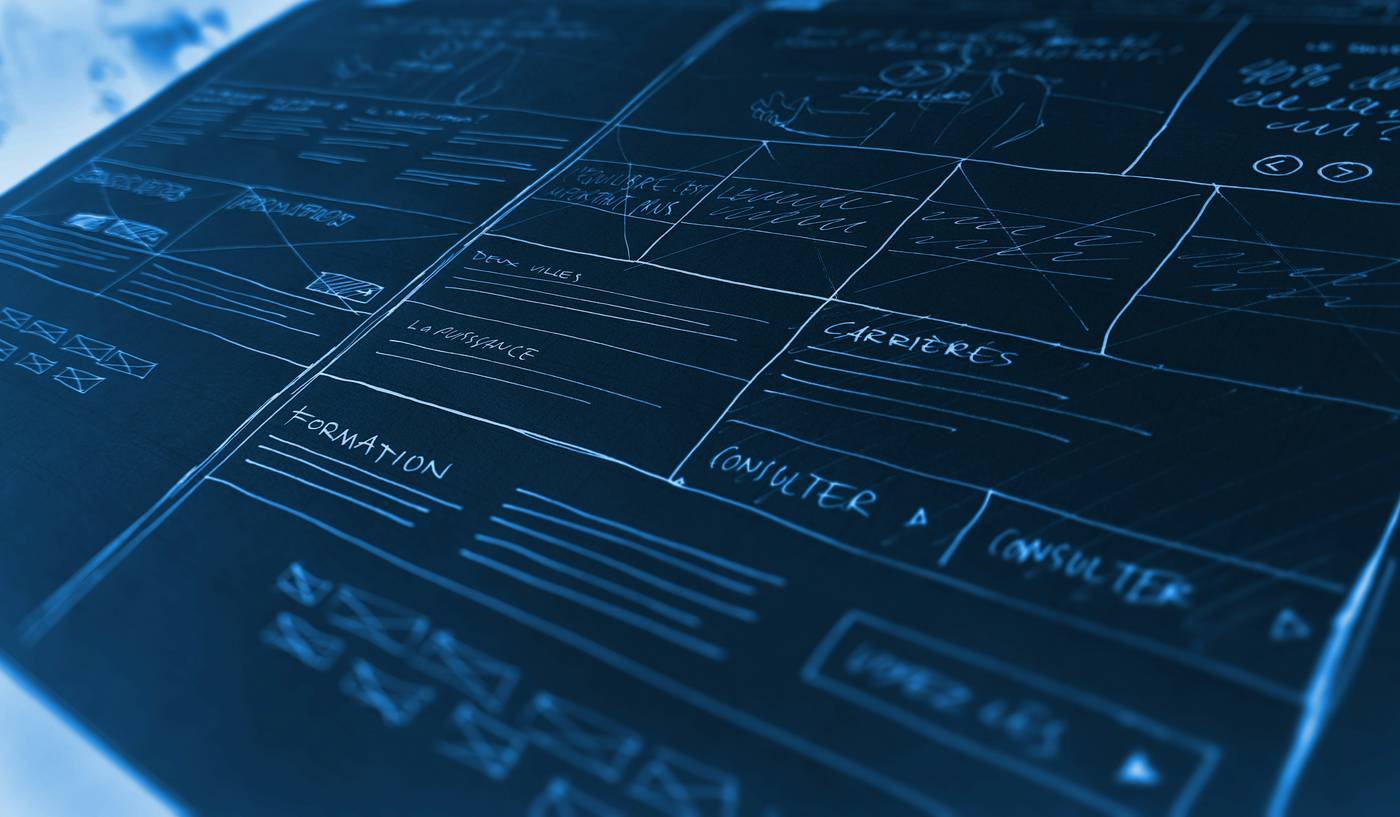 Architectural wireframe sketches on a blueprint